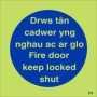 Glow in the dark Fire Door Keep Locked Shut sign in Welsh and English