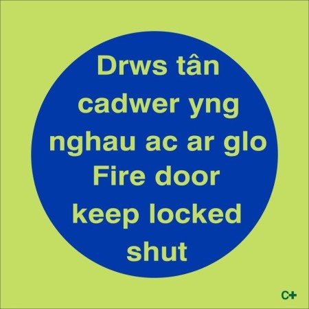 Glow in the dark Fire Door Keep Locked Shut sign in Welsh and English